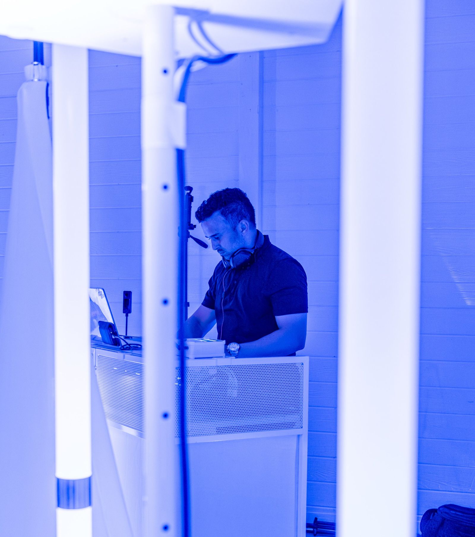 DJ Davin Titus at his booth in blue light